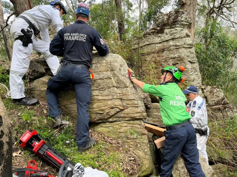 WOMAN TRAPPED UPSIDE DOWN BETWEEN BOULDERS WHILE GRASPING FOR PHONE